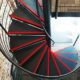 plan view of a back steel spiral staircase with red stripes on steps