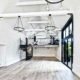 bright white internal shot of a barn conversion with a steel spiral staircase