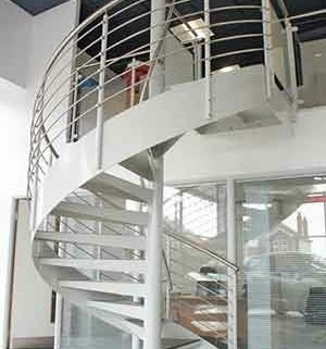 showroom setting with a white spiral stair rising