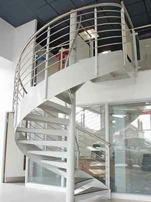 showroom setting with a white spiral stair rising