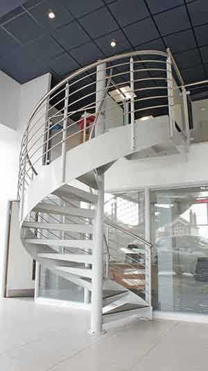 showroom setting with a white spiral stair rising