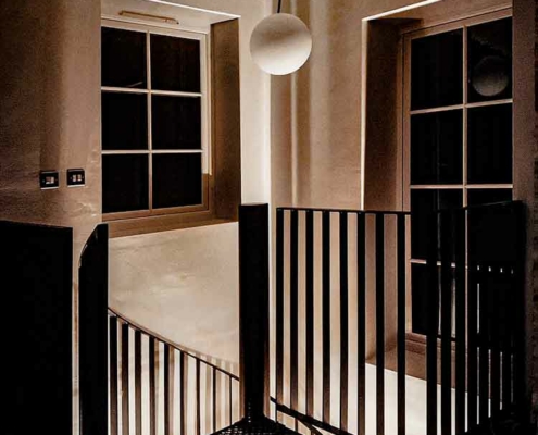 dark picture of a square platform at the top of a spiral staircase