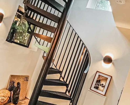 slanted picture of a black steel spiral staircase