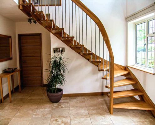 hallway with open riser stair and green plant below