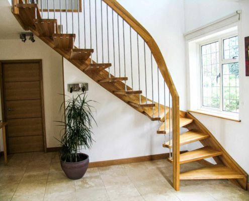 window to side of hallway with oak staircase