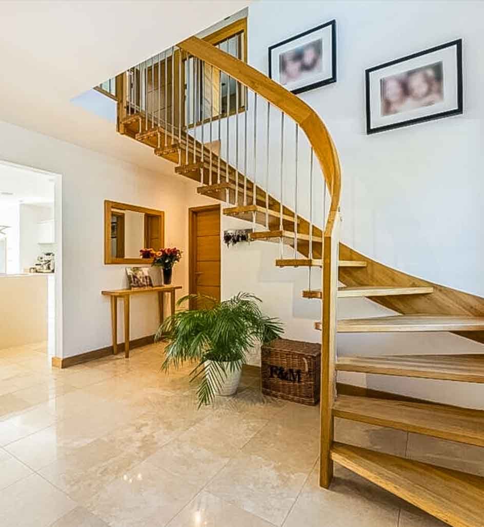 tiled floor with open staircase with green plant below