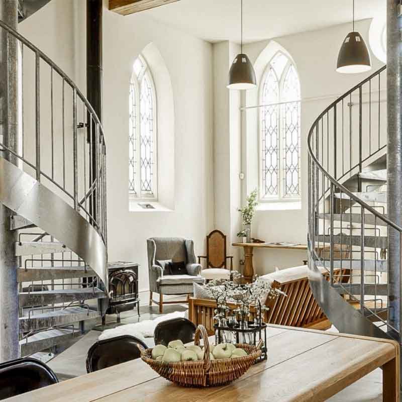 wooden table and two steel spiral stairs