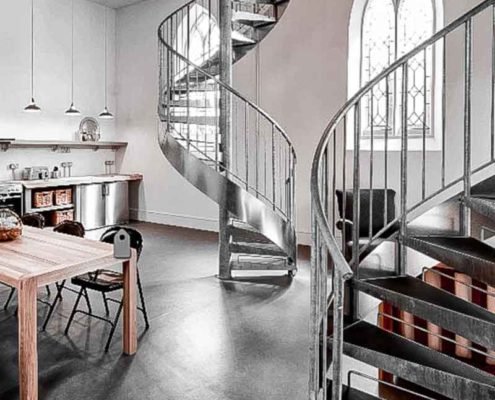 polished concrete floor with grey steel spiral stairs