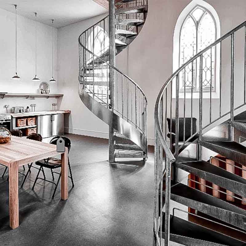 polished concrete floor with grey steel spiral stairs