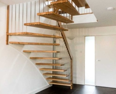 black tiles in a hallway with floating style oak stair