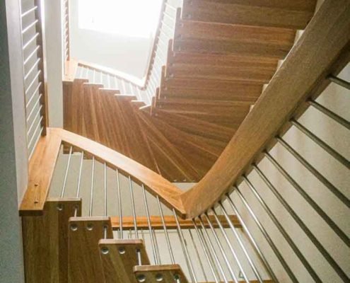 light above a stairwell with two floating timber stairs
