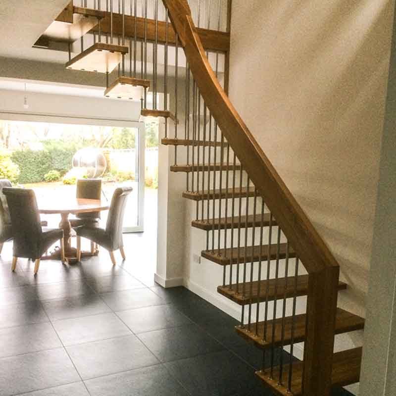 hallway in house with black tiles and floating style stair
