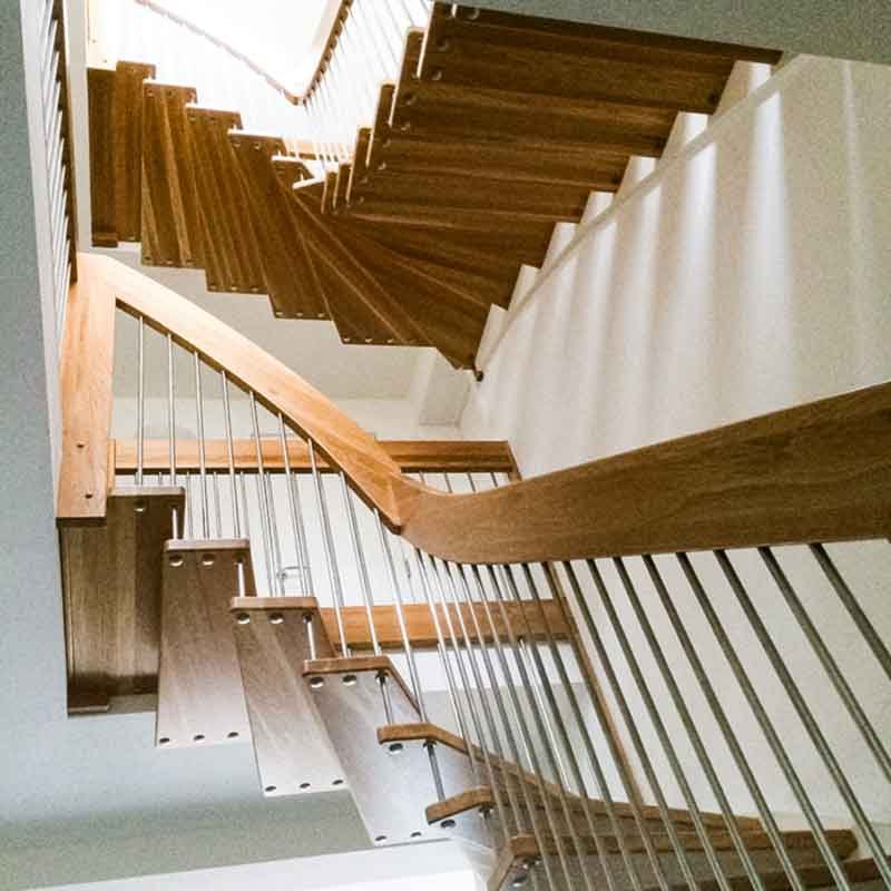 two open stairs in a house with floating oak steps