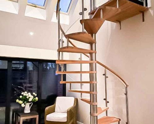 Glass, wood and stainless spiral stair with roof lights above