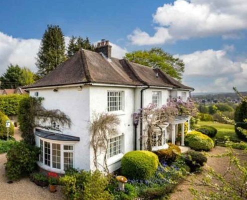 White house with garden surround and blue sky