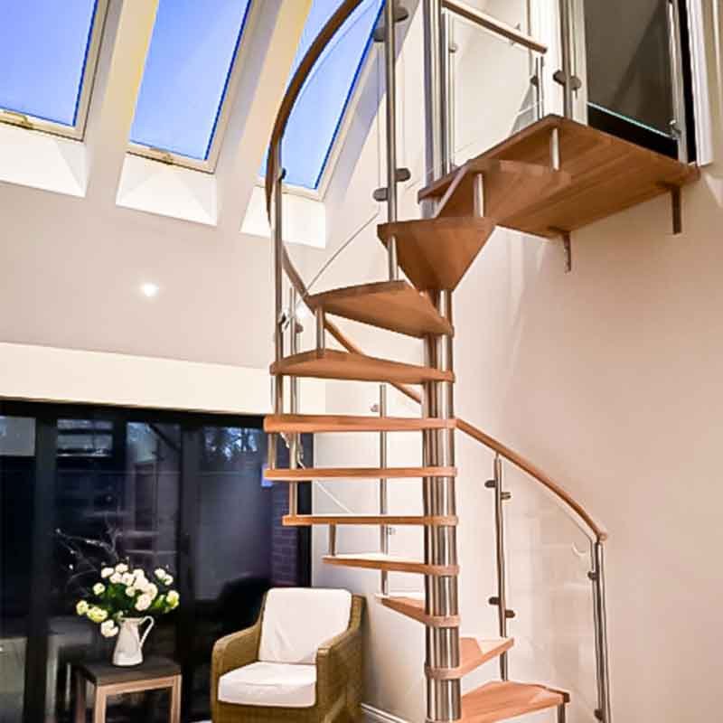 glass and wood spiral stair in a house
