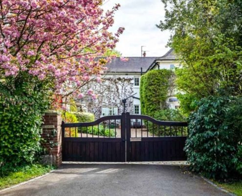 White house with wooden entry gate