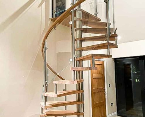 modern spiral stair with a white wall
