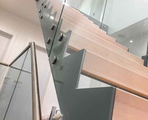 glass panel to side of steel and wood stair
