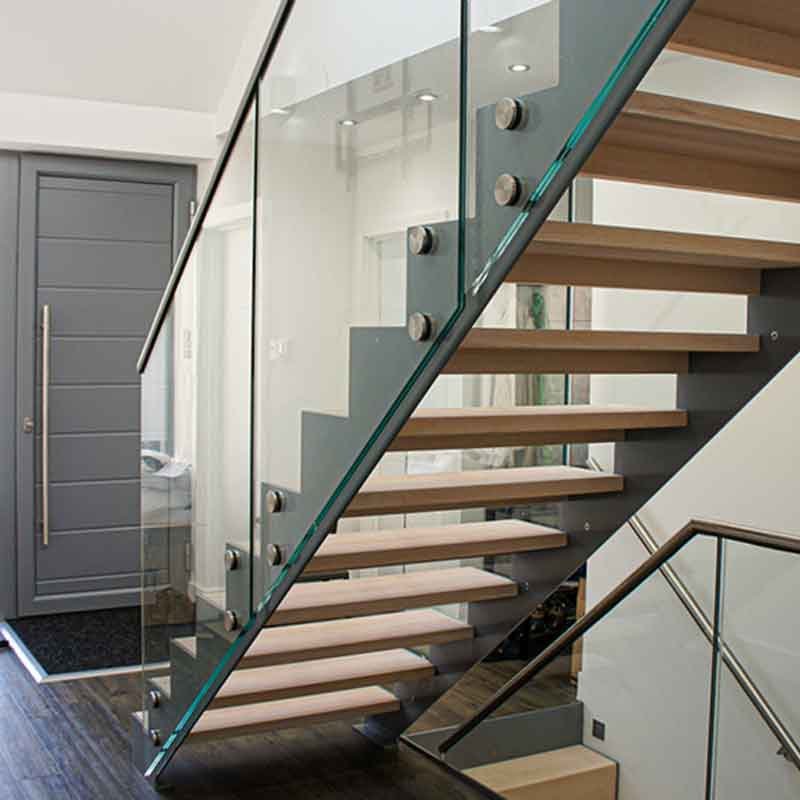 rear view of open riser staircase with glass panels