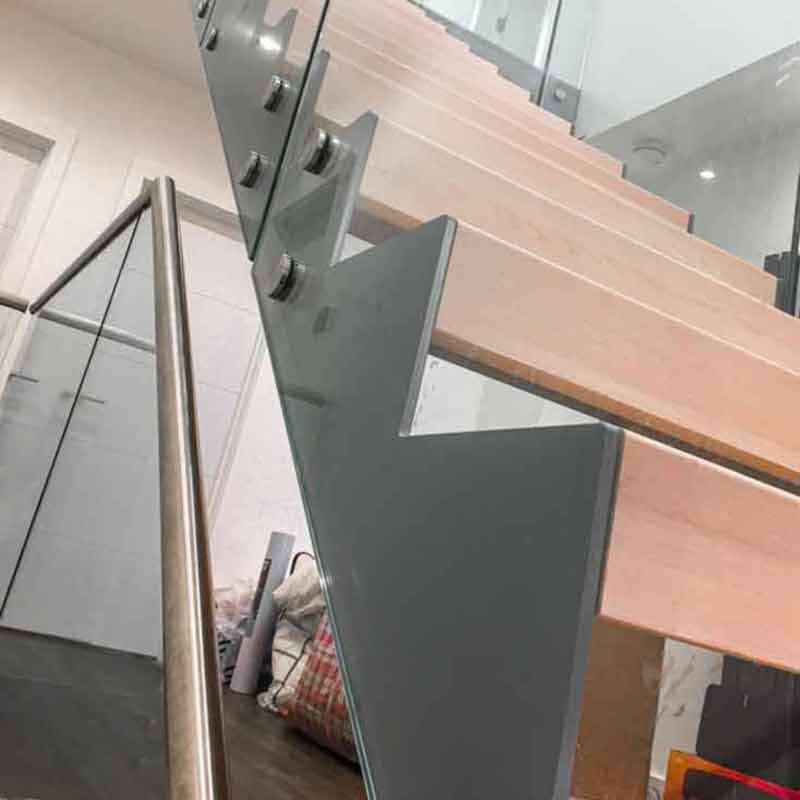 glass panel to side of steel and timber stair