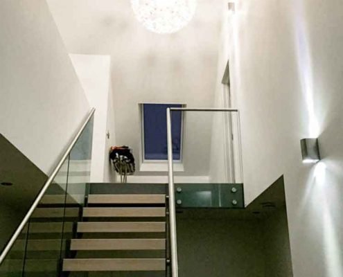 hallway with feature light and staircase