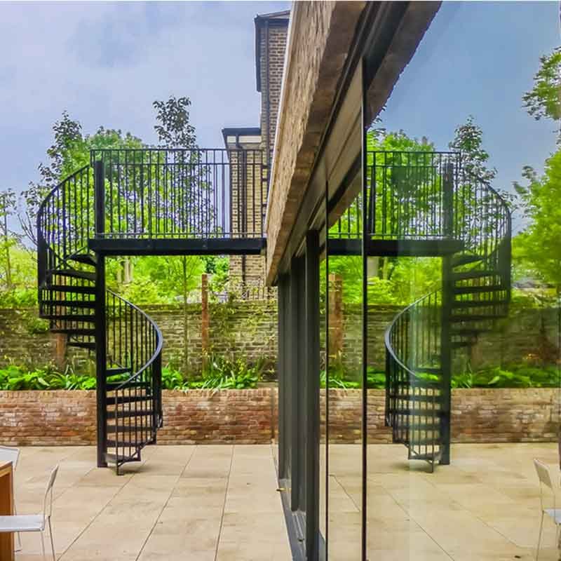 black spiral stair with reflection in window