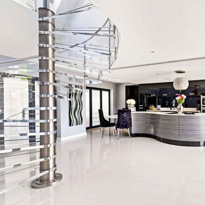 stainless spiral stair with kitchen beyond