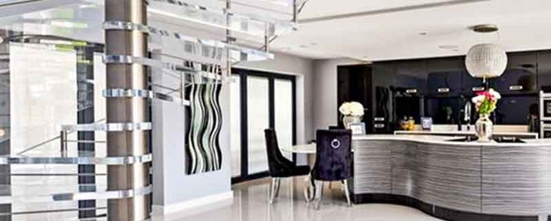 stainless spiral stair with kitchen beyond