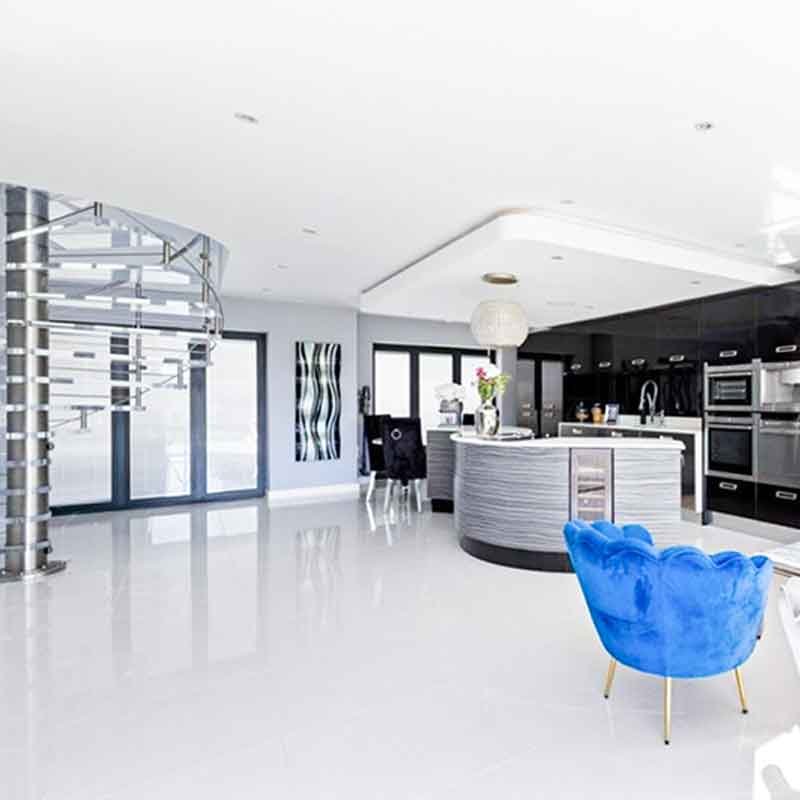 modern kitchen with blue chair and spiral stair