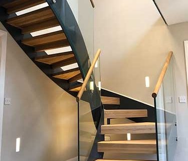 half turn open riser stair in Great Easton with glass balustrade