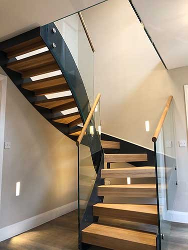 half turn open riser stair in Great Easton with glass balustrade