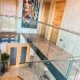 glass balustrade with stainless handrail around the landing area above a model 500 stair
