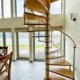 Loch-Ness spiral stair with large window behind with lake view