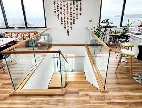 half turn modern steel and oak staircase with glass balustrade