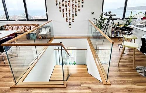 half turn modern steel and oak staircase with glass balustrade