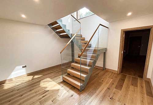 half turn steel and glass stair and oak treads
