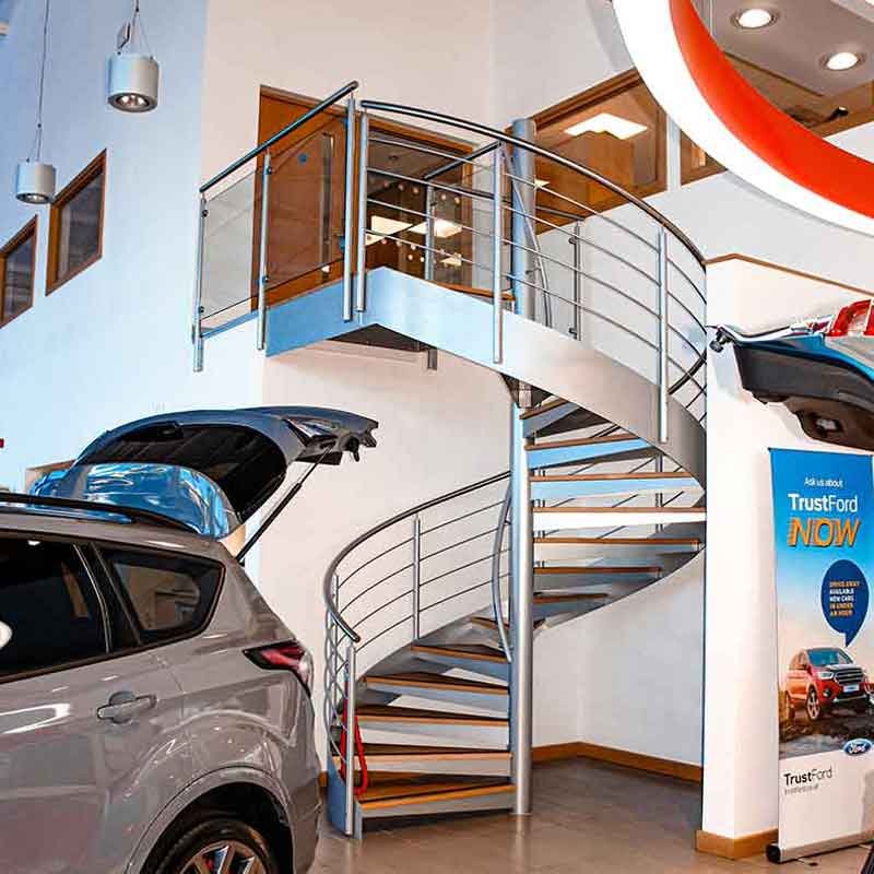 Grey-Steel-spiral-stair-in-an-Epsom-car-showroom Grey-Steel-spiral-stair-in-an-Epsom-car-showroom