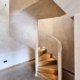 Spiral-stair-with-solid-wall-balustrade-and-oak-treads