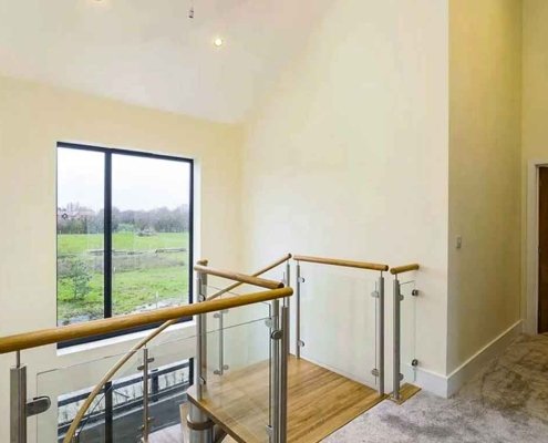 Square-oak-platform-at-the-top-of-a-spiral-staircase-installed-in-a-new-hosue-in-canterbury