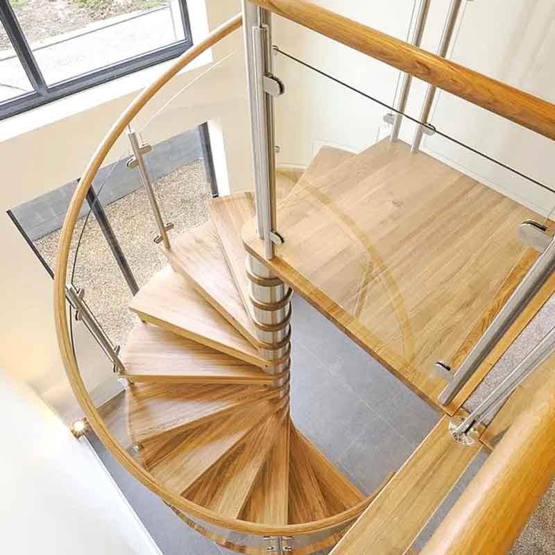 View-looking-down-on-the-oak-steps-of-a-modern-spiral-staircase-in-a-house