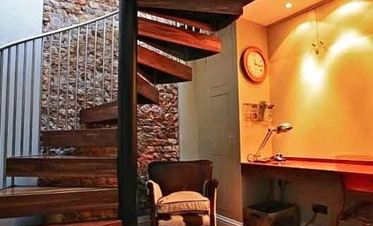Walnut-and-black-steel-spiral-staircase-in-a-Chiswick-home