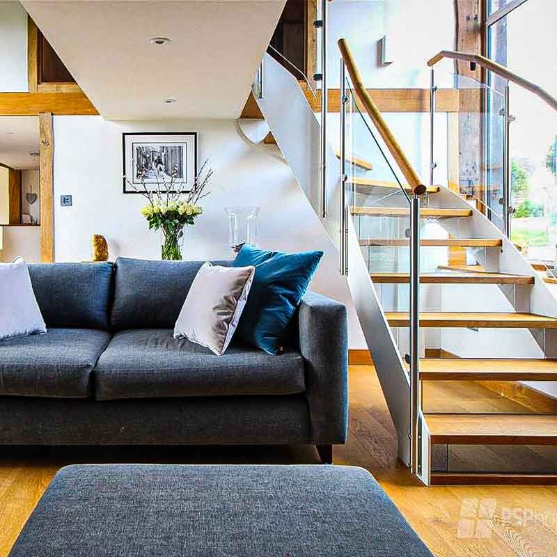 Glass-Staircase-Haywards-Heath-in-living-room-with-grey-sofa