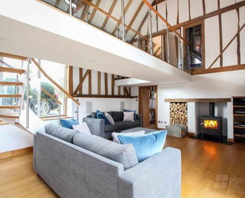 Glass-Staircase-Haywards-Heath-oak-framed-living-area-of-converted-barn