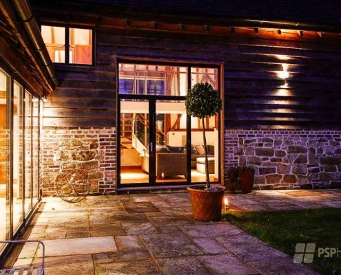 Glass-Staircase-Haywards-Heath-rear-patio-with-timber-frame-barn