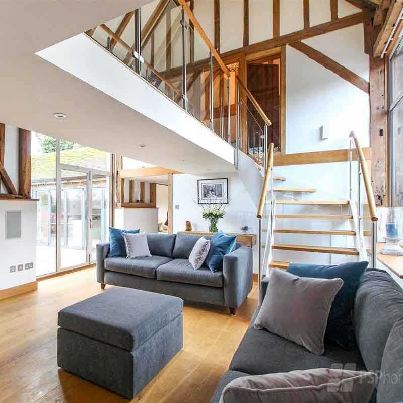 Glass-Staircase-Haywards-Heath-with-grey-sofas-downstairs
