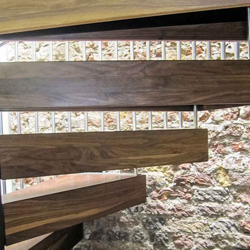 Thick-walnut-treads-on-a-spiral-installed-in-chiswick