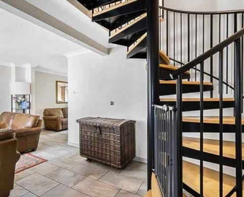 Black-steel-and-wood-spiral-stair-in-a-living-area