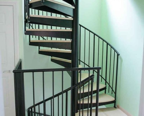 Mint-coloured-wall-with-black-spiral-staircase