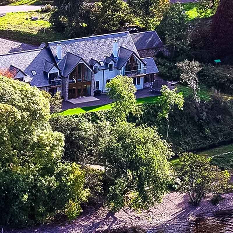 view of a house from above with green garden